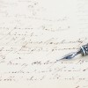 old  feather pen on  handwritten letter background